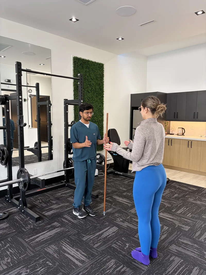 Physiotherapist talking with a patient in the rehab gym at Interlink Physiotherapy